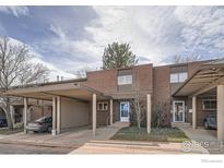 Brick townhouse exterior with carport and landscaping at 1518 Chambers Dr, Boulder, CO 80305