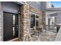 Inviting front porch with stone accents and modern entryway at 1524 Sun Way, Lafayette, CO 80026