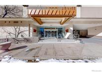 Modern building exterior with a glass entryway and a metal awning at 1777 Larimer St # 1608, Denver, CO 80202