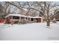 Brick ranch home with snowy front yard and mature trees at 2250 Grape Ave, Boulder, CO 80304