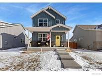 Two-story craftsman style home with a welcoming front porch and landscaping at 306 Se 4Th St, Berthoud, CO 80513