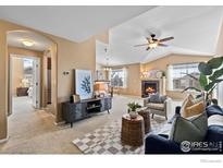 Bright living room with fireplace, vaulted ceiling and comfy seating at 3100 Blue Sky Cir # 308, Erie, CO 80516