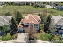 Aerial view of house, showcasing its red tile roof and landscaping at 380 Edison Pl, Superior, CO 80027