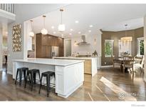 Spacious kitchen with an island, breakfast nook, and ample counter space at 1702 Montgomery Cir, Longmont, CO 80504