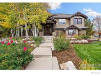 Two-story home with stone accents and landscaped yard at 2121 Jade Way, Longmont, CO 80504