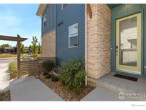 Modern home exterior with stone and blue siding, plus a landscaped walkway at 755 Cristo Ln # C, Lafayette, CO 80026