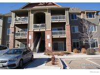Exterior view of a two-story apartment building with parking and landscaping at 804 Summer Hawk Dr # 9106, Longmont, CO 80504