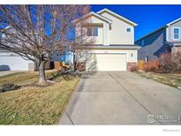 Two-story house with attached garage and landscaping at 10517 Taylor Ave, Firestone, CO 80504