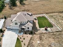 Aerial view of a two-story house with a large backyard, playground, and detached garage at 1221 W 144Th Ct, Westminster, CO 80023