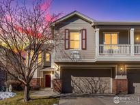 Two-story townhome with a red door and attached garage at 12988 Grant W Cir # A, Thornton, CO 80241