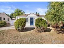 Charming ranch home with a well-maintained lawn and blue front door at 4455 S Logan St, Englewood, CO 80113