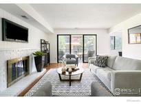 Bright living room with fireplace and access to a balcony at 600 Manhattan Dr # B6, Boulder, CO 80303