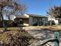 Ranch style home with carport and landscaping at 7901 Newport St, Commerce City, CO 80022