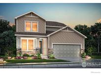 Charming two-story home with a well-manicured lawn and stone accents on the facade and a two car garage at 793 Griffith St, Lochbuie, CO 80603