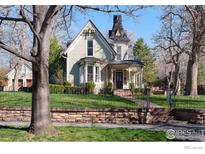 Beautiful Victorian home with landscaped yard and ornate detailing at 809 Pine St, Boulder, CO 80302