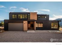 Modern home with dark exterior and mountain views at 104 Old Sunshine Trl, Boulder, CO 80302