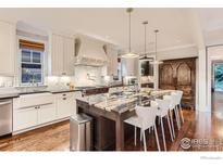 Gourmet kitchen with large island, stainless steel appliances, and granite countertops at 1175 S Corona St, Denver, CO 80210