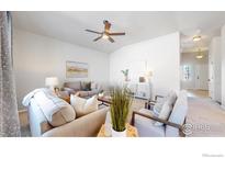 Bright living room featuring neutral tones, comfy seating, and a cozy atmosphere at 1352 Murrlet St, Berthoud, CO 80513