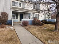 Inviting exterior of a townhome with landscaping and walkway at 1419 Red Mountain Dr # 71, Longmont, CO 80504