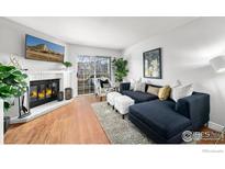 Spacious living room featuring a fireplace and comfortable seating at 1818 S Quebec Way # 13-2, Denver, CO 80231