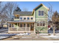 Charming two-story green house with wrap-around porch at 2613 Thornbird Pl, Boulder, CO 80304