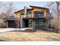 Modern two-story home with gray and wood siding, a balcony, and attached garage at 2940 14Th St, Boulder, CO 80304