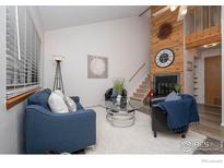 Cozy living room features a fireplace and comfortable seating at 380 S Taft Ct, Louisville, CO 80027