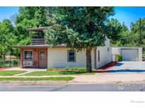 Cute two-story house with a deck and landscaped yard at 4525 S Delaware St, Englewood, CO 80110