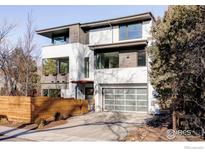 Modern two-story home with attached garage and wood fence at 635 Arapahoe Ave # A, Boulder, CO 80302