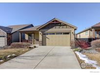 Ranch style home with a two-car garage and well-manicured landscaping at 724 Widgeon Cir, Longmont, CO 80503