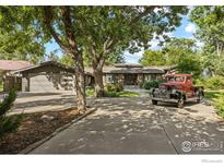 Ranch style home with attached garage and mature landscaping at 819 Gapter Rd, Boulder, CO 80303