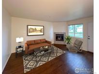 Living room with fireplace and hardwood floors at 1601 Great Western Dr # A7, Longmont, CO 80501