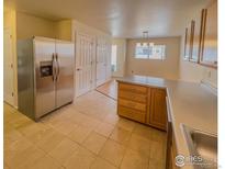 Stainless steel appliances and light wood cabinets in this kitchen at 1601 Great Western Dr # R1, Longmont, CO 80501