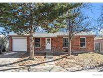 Brick ranch house with attached garage and landscaping at 1740 Shallot Cir, Lafayette, CO 80026