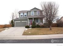 Two-story house with attached garage and landscaped front yard at 6297 Clayton Cir, Frederick, CO 80530