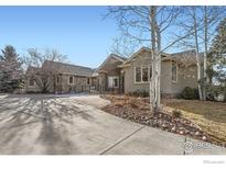 Craftsman style home with stone accents and a large driveway at 8777 Comanche Rd, Niwot, CO 80503