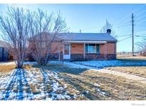 Brick ranch house with a yard and walkway at 940 E 89Th Ave, Thornton, CO 80229