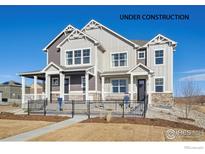 Two-story craftsman style home under construction with a landscaped front yard and fence at 948 Andrews Crest Dr, Berthoud, CO 80513