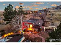 Lovely home with deck, patio, and landscaping nestled on a hillside at 12041 Twilight St, Longmont, CO 80503