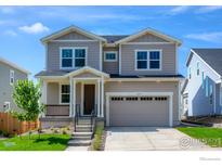 Two-story house with beige siding, brown door, and a two-car garage at 2437 Bristol St, Superior, CO 80027