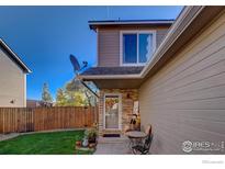 Two-story townhome with a landscaped front yard and a patio at 421 Stevens Cir, Platteville, CO 80651