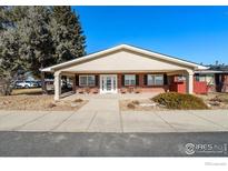 Brick ranch-style home with covered porch and landscaping at 5425 County Road 32, Mead, CO 80504