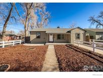 Updated Ranch home with a landscaped yard and white picket fence at 990 Hazel Ct, Denver, CO 80204