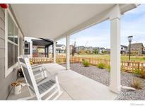 Inviting front porch with rocking chairs and views of the neighborhood at 129 Mesa Way, Superior, CO 80027