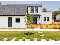 Two-story modern farmhouse with white siding, dark trim, and a landscaped front yard at 2130 22Nd St, Boulder, CO 80302