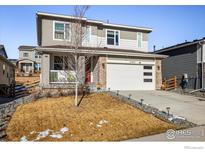 Two-story home with attached garage and landscaping at 21837 E Stanford Cir, Aurora, CO 80015