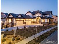 Stunning two-story home with a three-car garage and landscaped front yard at 2294 Stonebrae Ct, Berthoud, CO 80513