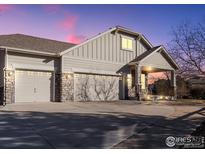 Craftsman style home with three-car garage and landscaped yard at 4355 W 107Th Dr, Westminster, CO 80031