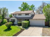 Charming two-story home with a well-manicured lawn and an attached two-car garage, nestled on a sunny lot at 4667 Ashfield Dr, Boulder, CO 80301