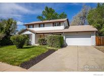 Charming two-story home with a well-maintained lawn, two car garage, and beautiful landscaping at 4667 Ashfield Dr, Boulder, CO 80301